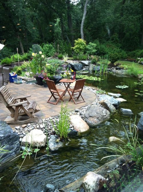  alt='We are absolutely thrilled with our lakeside landscaping! We now have a boulder bulkhead that will never rot; I have a'
