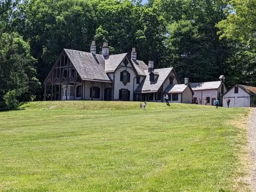 Cool combination of the farm and green open spaces / fields as well as historical buildings and family transportation